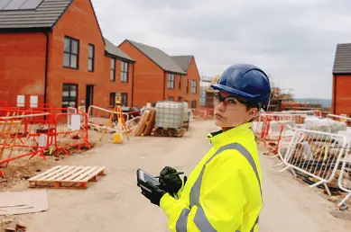 New-build brick housing plots part-way through construction